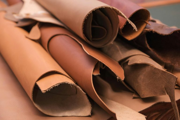 Array of leather fabric samples in different shades neatly placed on a table, ready to be crafted